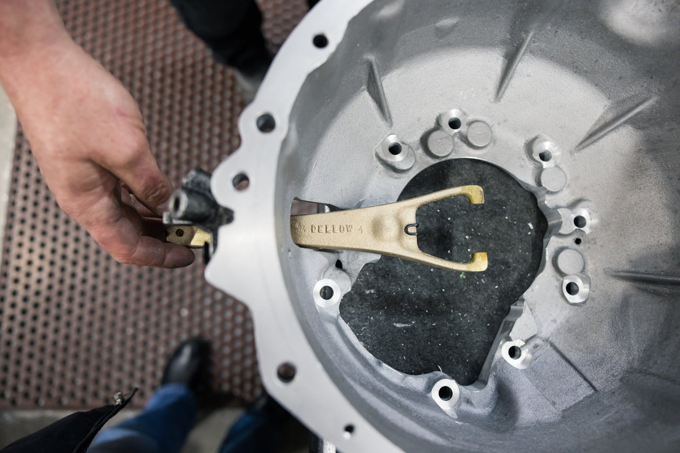 Top view of bellhousing and mans hands measuring